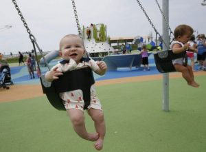 babies in swings at playground